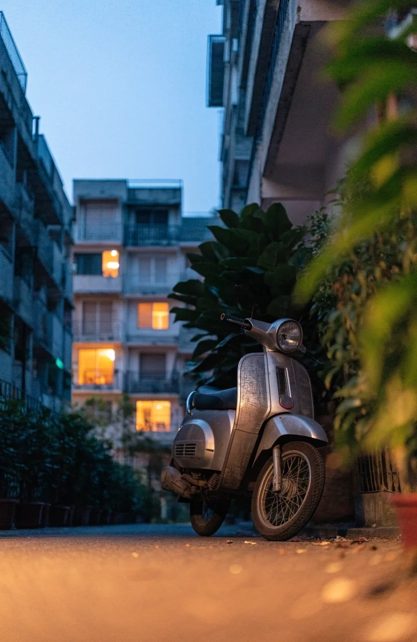A quiet Jakarta residential street at dusk with lit apartment windows